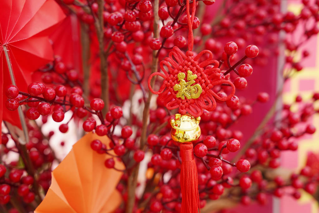 幸运的结挂在花朵上表示新年的问候，汉字表示新年的祝福